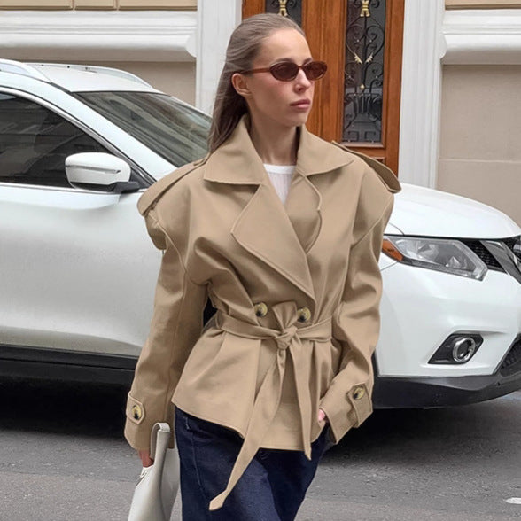 Khaki lace-up trench coat for women styled with sunglasses in city streets.